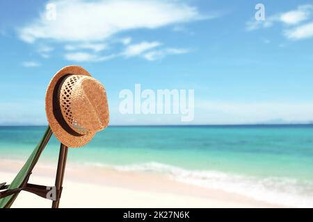 Vacation background with straw hat and bright tropical beach Stock Photo