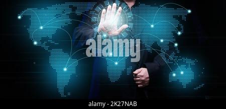 a businessman establishes communication and exchange of information between the continents on a virtual holographic map of the world. Global network Stock Photo