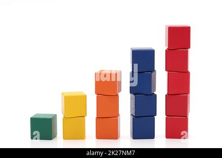 Stack of colorful wooden building blocks on white background Stock Photo