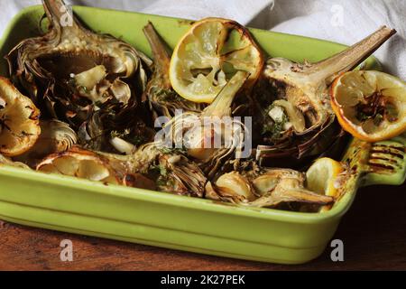 fried artichokes with garlic and lemon on pan Stock Photo