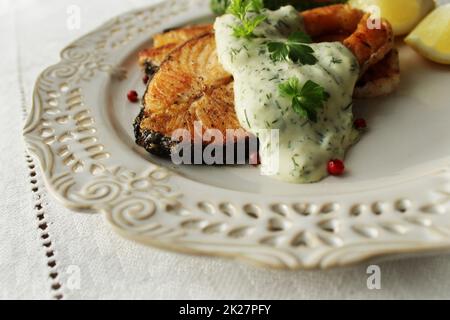 Salmon. Grilled salmon steak with sauce and lemoni on white plate Stock Photo