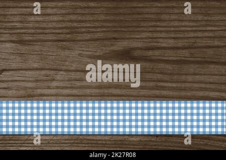 Checkered blue tablecloth on old brown wooden table Stock Photo