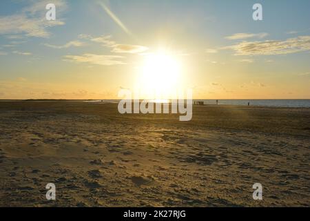 Sunset at low tide over the sea  with sand beach Stock Photo