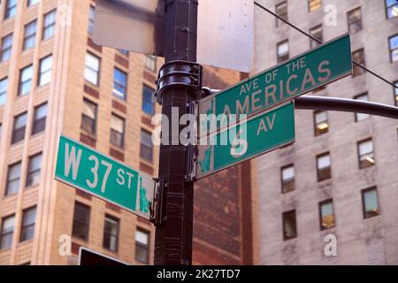 Green West 37th Street and Avenue of the Americas 6th traditional sign in Midtown Manhattan Stock Photo