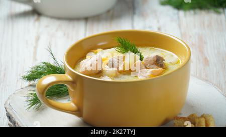 Creamy fish soup with salmon, potatoes, onions , carrots, dill and celery . Kalakeitto- traditional dish of the Finnish cuisine or Russian  Ukha Fish Head Soup. Healthy Food Concept. Omega -3 Stock Photo