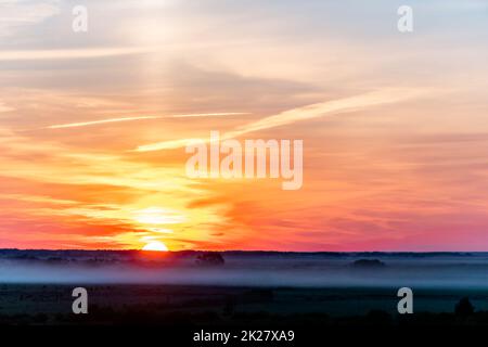The heavenly light of the sun.Dramatic evening sky with clouds and rays of the sun.Sunlight at evening sunset or morning sunrise.Panoramic view of clouds in motion.Golden rays of the sun and clouds Stock Photo