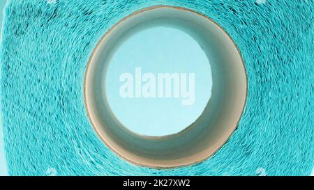 Blue roll of modern toilet paper on a blue background. A paper product on a cardboard sleeve, used for sanitary purposes from cellulose with cutouts for easy tearing. Embossed drawing Stock Photo