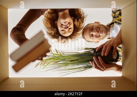 Couple packing boxes for move bottom view Stock Photo
