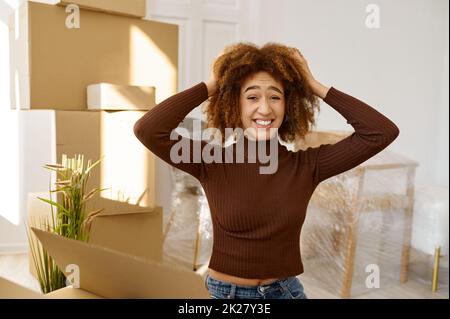 Happy but quite exhausted woman moving home Stock Photo