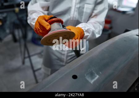 Closeup auto mechanic hands with orbital polisher Stock Photo