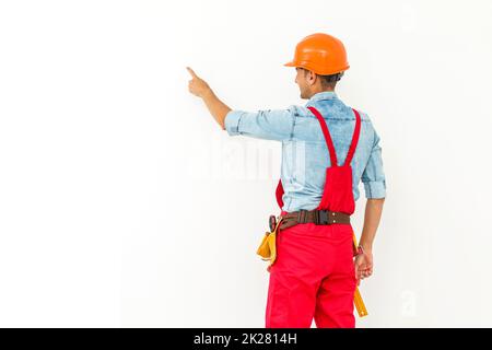 full length of builder in helmet with plan in hands points at something isolated on white background Stock Photo