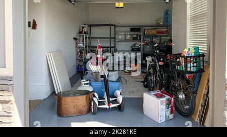 Orlando, FL USA - March 3, 2022: An unorganized garage filled with a lot of stuff in a neighborhood. Stock Photo