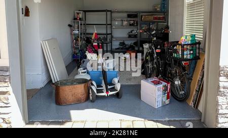 Orlando, FL USA - March 3, 2022: An unorganized garage filled with a lot of stuff in a neighborhood. Stock Photo