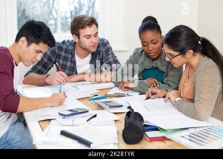 Helping each other through finals revision. a group of university students in a study group. Stock Photo