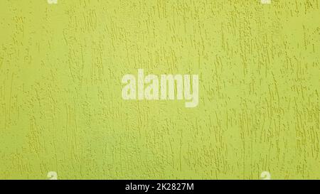 Old gold plaster wall texture yellow background. Textured textured wall plaster. Embossed wall decoration. Stucco walls. Embossed wall decoration. Decorative plaster is painted yellow. Stock Photo