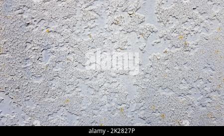 Gray metal wall background. Light peeling texture. Dirty rusty metal wall. Retro effect Cracks, grunge, rough stucco. Old gray metal door. Old gray cracked paint on a metal door.