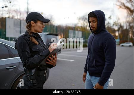 Upset man and police woman issuing fine Stock Photo