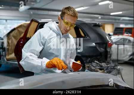 Mechanic engaged in local repairing car body Stock Photo