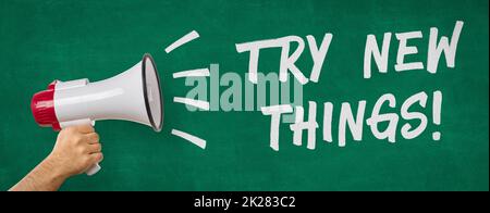A man holding a megaphone - Try new things Stock Photo