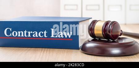 A law book with a gavel - Contract law Stock Photo