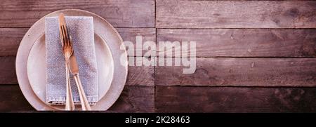 Place setting in vintage pink on old wood Stock Photo