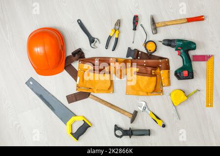 set of construction tools in toolbelt close up on wooden board Stock Photo