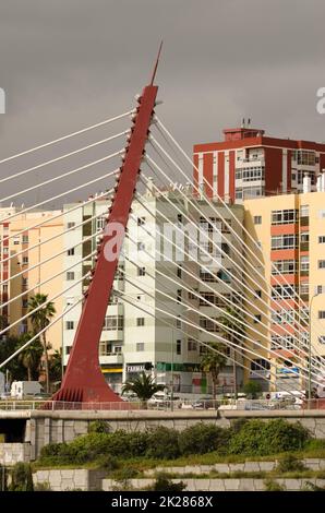 Cable-stayed bridge over a ravine and buildings. Stock Photo