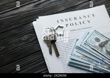 Home insurance policy with keys and dollar money mortgage, loan or home insurance documents Stock Photo