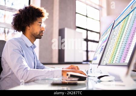 Data Analyst African Man Using Spreadsheet Stock Photo