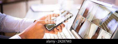 African American Using Security And Alarm System Stock Photo