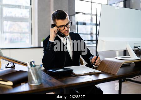 Young Businessman Talking On Landline Phone Stock Photo