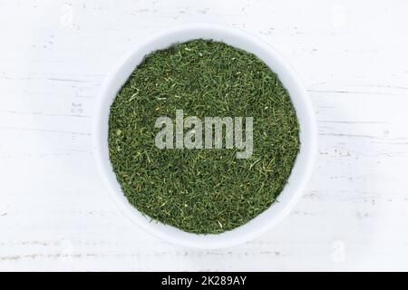 Dill herb from above bowl wooden board Stock Photo