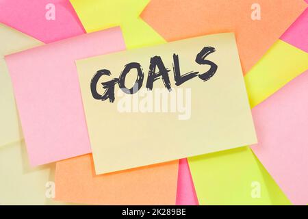 Goal goals to success aspirations and growth business concept note paper Stock Photo