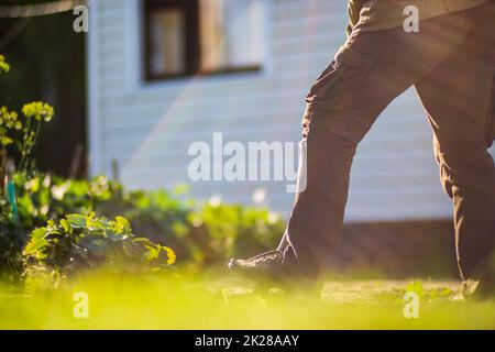 The farmer digs the soil in the vegetable garden. Preparing the soil for planting vegetables. Gardening concept. Agricultural work on the plantation Stock Photo