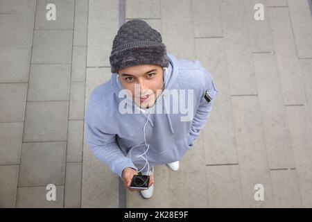 Listening to music young latin man runner sports training from above top view Stock Photo