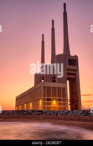 The disused thermal power station at Sand Adria near Barcelona at sunset Stock Photo