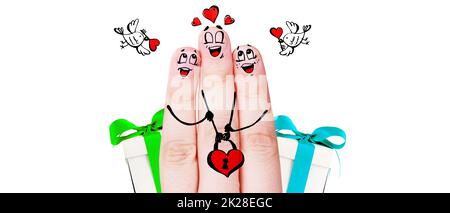 Finger puppets of loving parents with young child hugging and having fun. Stock Photo