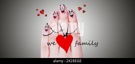 Finger puppets of loving parents with young child hugging and having fun. Stock Photo