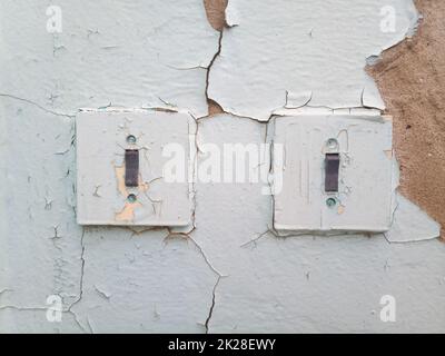 Switches on the old wall. Very old house Stock Photo