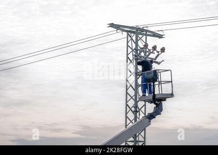 repair of high voltage power line on the pole Stock Photo