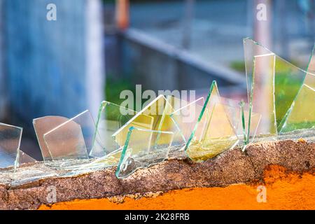 Dangerous wall with broken glass shards Playa del Carmen Mexico. Stock Photo