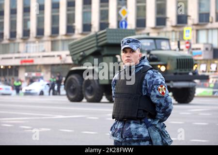 Russian soldier standing in front of multiple launch rocket system 'Tornado' on city street Stock Photo