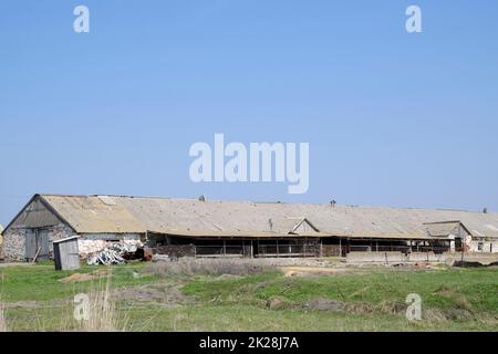 Old farm building. Leaky slate roof on the farm Stock Photo