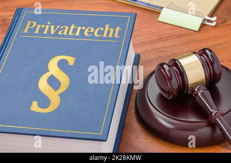A law book with a gavel -  German Translation of Private law - Privatrecht Stock Photo