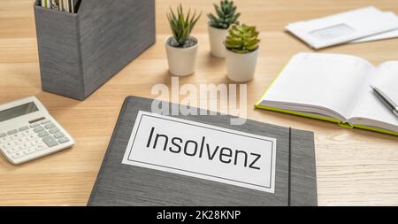 A folder on a desk with the label Insolvency in german - Insolvenz Stock Photo