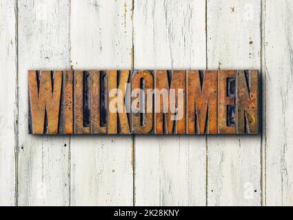 Antique letterpress wood type printing blocks - Welcome in german - Willkommen Stock Photo