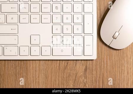 Keyboard from a computer and a computer mouse on a desk in the office Stock Photo