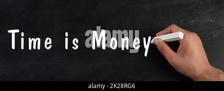 Time is money is standing on a chalkboard, finance knowledge and strategy, working for salery, business concept Stock Photo