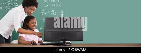 African American Teacher And Math Student In Computer Classroom Stock Photo