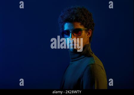 Young serious man in eyeglasses studio headshot Stock Photo